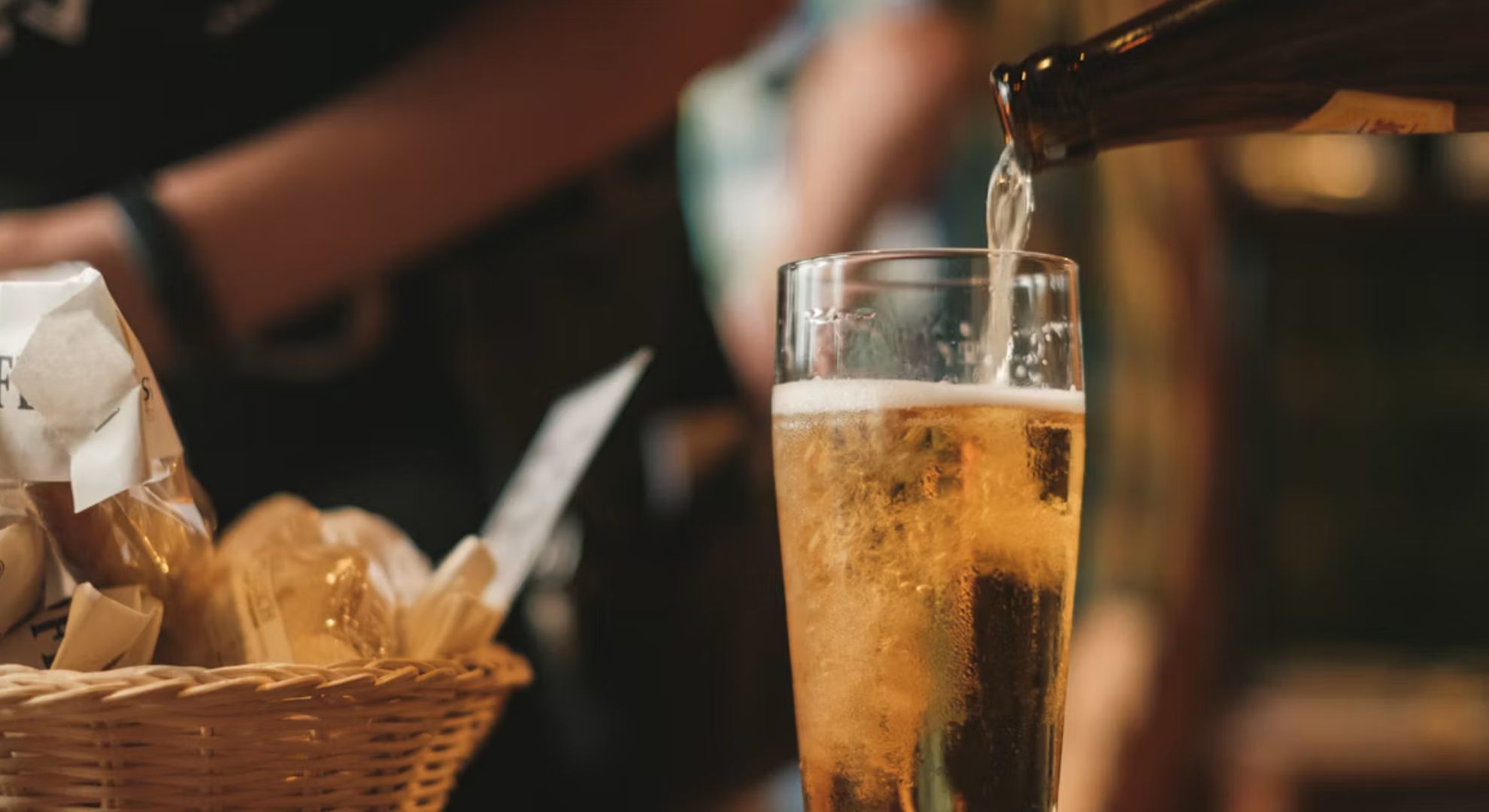 Beer being poured into a glass at a bar